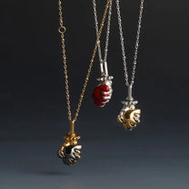 Arms of My Romeo – Black Heart &amp; Gold Hand Pendant